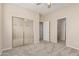 Bedroom with neutral walls and carpet plus closet with mirrored sliding doors at 4336 W Hackamore Dr, Phoenix, AZ 85083