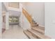 Inviting entryway with wood-look stairs and open floor plan that leads to a carpeted living area and an upstairs balcony at 4336 W Hackamore Dr, Phoenix, AZ 85083