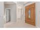 Bright foyer featuring tile flooring, a stained wood door with glass inset, and neutral paint at 4336 W Hackamore Dr, Phoenix, AZ 85083