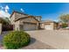 Two-story home featuring a spacious three-car garage, desert landscaping, and tile roof at 4336 W Hackamore Dr, Phoenix, AZ 85083