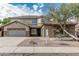 Charming home featuring a spacious three-car garage, stone accents, desert landscaping, and tile roof at 4336 W Hackamore Dr, Phoenix, AZ 85083