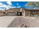 Charming home featuring a spacious three-car garage, stone accents, desert landscaping, and tile roof at 4336 W Hackamore Dr, Phoenix, AZ 85083