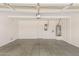 Two car garage featuring an automatic door, water heater, and room for a workbench at 4336 W Hackamore Dr, Phoenix, AZ 85083