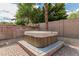 Outdoor hot tub with privacy fence and mature tropical landscaping at 4336 W Hackamore Dr, Phoenix, AZ 85083