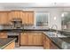 Bright kitchen featuring stainless steel appliances, wooden cabinets, and stylish backsplash, next to a sink at 4336 W Hackamore Dr, Phoenix, AZ 85083