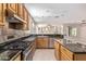 Open kitchen featuring stainless steel appliances and granite counters seamlessly flowing into a living space at 4336 W Hackamore Dr, Phoenix, AZ 85083
