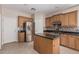 Well-lit kitchen with stainless steel appliances, tile flooring and granite counters, complete with an island at 4336 W Hackamore Dr, Phoenix, AZ 85083