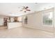 Living room with tile flooring, a kitchen bar, stainless steel appliances, and plenty of natural light at 4336 W Hackamore Dr, Phoenix, AZ 85083