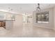 Open-concept living area with tile flooring, a kitchen counter, and windows that offer views of the backyard at 4336 W Hackamore Dr, Phoenix, AZ 85083