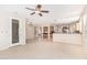 Bright, open living space with tile flooring, a kitchen bar, and an entryway that leads to other rooms at 4336 W Hackamore Dr, Phoenix, AZ 85083