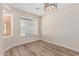 Bright office space with wood flooring, a modern light fixture, and a window for natural light at 4336 W Hackamore Dr, Phoenix, AZ 85083