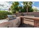 Outdoor kitchen area featuring a stainless steel grill and brick surround in a landscaped backyard at 4336 W Hackamore Dr, Phoenix, AZ 85083