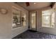 Cozy covered patio with brick pavers, large windows and view of backyard landscaping at 4336 W Hackamore Dr, Phoenix, AZ 85083
