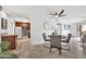 Bright dining area with a modern ceiling fan, adjacent to an updated kitchen and sliding glass doors to the patio at 4354 N 82Nd St # 167, Scottsdale, AZ 85251