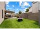 The backyard features artificial grass, a fire pit, a patio, and block fence for privacy at 441 S Maple -- # 83, Mesa, AZ 85206