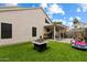 A backyard with a covered patio area, artificial grass and fire pit area provides outdoor entertainment at 441 S Maple -- # 83, Mesa, AZ 85206