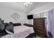 Cozy bedroom featuring a large decorative chest of drawers, mounted TV, and plush bedding at 441 S Maple -- # 83, Mesa, AZ 85206