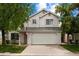 Charming two-story home featuring a two-car garage, a well-manicured lawn, and mature trees in a residential neighborhood at 441 S Maple -- # 83, Mesa, AZ 85206