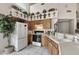 Cozy kitchen featuring wood cabinets, white appliances, and ample counter space for meal preparation and dining at 441 S Maple -- # 83, Mesa, AZ 85206