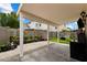 A covered patio provides shade for the brick floor, while plants line the back, along with a patch of artificial turf at 441 S Maple -- # 83, Mesa, AZ 85206