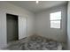 A simple bedroom with a sliding door closet and a window with natural light at 47451 W Kenner Dr, Maricopa, AZ 85139