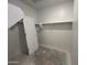Walk-in closet featuring white door, white walls, and shelves for storage at 47451 W Kenner Dr, Maricopa, AZ 85139