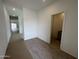 Hallway of a newly constructed home with wood tile flooring and white walls at 47451 W Kenner Dr, Maricopa, AZ 85139