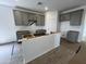 The gray cabinets give this kitchen a modern aesthetic at 47451 W Kenner Dr, Maricopa, AZ 85139