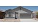 Charming single-story home featuring a two-car garage and low-maintenance desert landscaping at 47702 W Cansados Rd, Maricopa, AZ 85139
