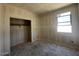Bright bedroom with a closet and window offering neighborhood views at 47719 W Kenner Dr, Maricopa, AZ 85139