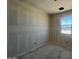 Well-lit bedroom with a window and closet awaiting carpet at 47719 W Kenner Dr, Maricopa, AZ 85139