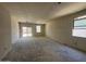 Large living room with natural light from windows and sliding door, ready for customization at 47719 W Kenner Dr, Maricopa, AZ 85139