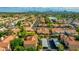 Extensive aerial view showcasing a desert community with solar panels, Spanish tile roofs, and palm tree-lined streets at 4901 E Kelton Ln # 1052, Scottsdale, AZ 85254