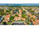 Community aerial view showcasing the Southwestern homes with red tile roofs, mature trees, convenient covered parking, and a pool at 4901 E Kelton Ln # 1052, Scottsdale, AZ 85254