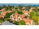 Serene aerial view of a vibrant desert community with Spanish tile roofs and mature green trees at 4901 E Kelton Ln # 1052, Scottsdale, AZ 85254