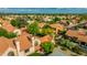Extensive aerial view showcasing a desert community with solar panels, Spanish tile roofs, and mature trees at 4901 E Kelton Ln # 1052, Scottsdale, AZ 85254