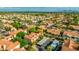Expansive aerial view of a community with Southwestern-style homes, lush landscaping, and mountain views in the distance at 4901 E Kelton Ln # 1052, Scottsdale, AZ 85254