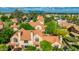 Gorgeous aerial view of the desert neighborhood featuring Spanish tile roofs, lush landscaping and mountain views at 4901 E Kelton Ln # 1052, Scottsdale, AZ 85254