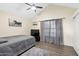 Bedroom featuring a ceiling fan, dark wood floors, and large window with curtains at 4901 E Kelton Ln # 1052, Scottsdale, AZ 85254