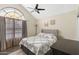 Bright bedroom featuring a large window, vaulted ceiling, and neutral decor at 4901 E Kelton Ln # 1052, Scottsdale, AZ 85254
