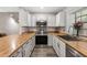 Modern kitchen with stainless steel appliances, white cabinets, and butcher block countertops at 4901 E Kelton Ln # 1052, Scottsdale, AZ 85254