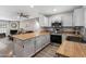 Open kitchen and living area with stainless steel appliances, butcher block counters, and fireplace at 4901 E Kelton Ln # 1052, Scottsdale, AZ 85254