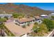 An aerial view highlights desert landscaping, mountain views, and surrounding desert terrain at 5801 E Surrey Dr, Cave Creek, AZ 85331