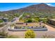 An aerial view of a home with mature landscaping, and a backdrop of mountain views at 5801 E Surrey Dr, Cave Creek, AZ 85331