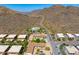 Aerial of a desert community nestled among mountains with visible roads and lush landscaping at 5801 E Surrey Dr, Cave Creek, AZ 85331
