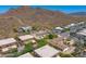 An aerial view shows the community and surrounding desert vegetation against a mountain backdrop at 5801 E Surrey Dr, Cave Creek, AZ 85331