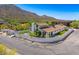 This aerial view showcases a home with mature trees, landscaping and mountain views at 5801 E Surrey Dr, Cave Creek, AZ 85331