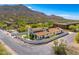 Aerial view of the home, showcasing the walled courtyard, mature trees, and mountain views at 5801 E Surrey Dr, Cave Creek, AZ 85331