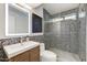 Modern bathroom featuring stylish vanity, lighted mirror, and a sleek glass-enclosed shower with patterned stone floor at 5801 E Surrey Dr, Cave Creek, AZ 85331