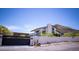 Modern home boasts a unique architectural design with desert landscaping and mountain views at 5801 E Surrey Dr, Cave Creek, AZ 85331